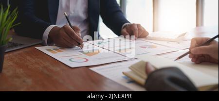 Smart businessman and businesswoman talking discussion in group meeting at office table in a modern office interior. Business collaboration strategic Stock Photo