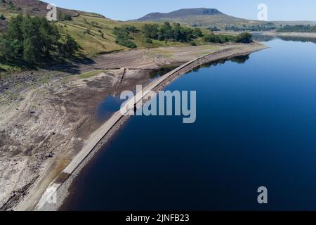 Llyn Celyn, Gwynedd, Wales August 11th 2022 - The old Bala and Ffestiniog Railway has emerged from the depths after the water level continues to drop. The railway line was flooded along with the village of Capel Celyn in 1965 to create the controversial Llyn Celyn Reservoir in Gwynedd the reservoir supplies water to the city of Liverpool. Pic by Credit: SCOTT CM/Alamy Live News Stock Photo