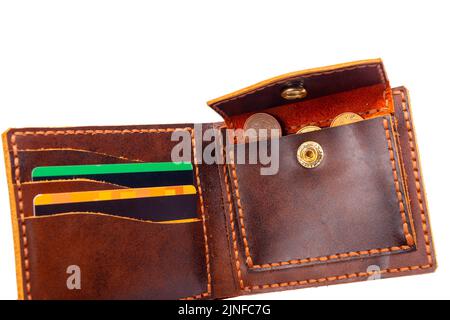 Open brown mens wallet with money and credit cards isolated on a white background close-up Stock Photo