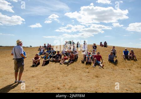 Guide speaking to tourists at the site of the Anglo-Saxon burial gounds at Sutton Hoo, Suffolk, England, UK Stock Photo