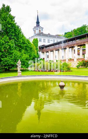 Lysice castle, Czech Republic. Famous baroque castle built in 14th century. Beautiful formal garden, palm trees and flowers. Promenade near the castle Stock Photo