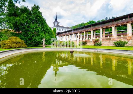 Lysice castle, Czech Republic. Famous baroque castle built in 14th century. Beautiful formal garden, palm trees and flowers. Promenade near the castle Stock Photo