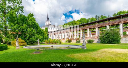 Lysice castle, Czech Republic. Famous baroque castle built in 14th century. Beautiful formal garden, palm trees and flowers. Promenade near the castle Stock Photo