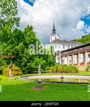 Lysice castle, Czech Republic. Famous baroque castle built in 14th century. Beautiful formal garden, palm trees and flowers. Promenade near the castle Stock Photo