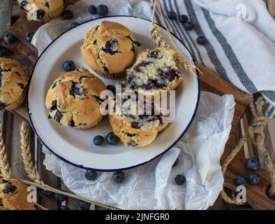 Fresh baked blueberry muffins on a rustic enamel plate Stock Photo