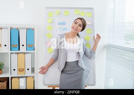 Happy young Vietnamese business lady dancing after working on project Stock Photo