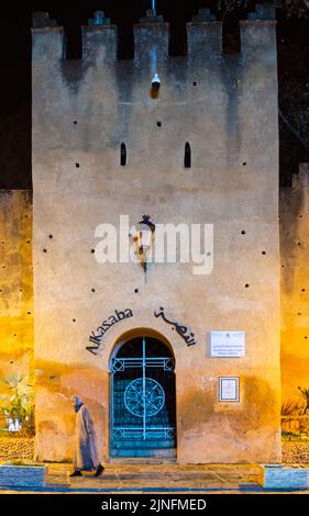 Chefchaouen, Morocco - 16 January 2022 : The door of Al Kasba in Chefchaouen city and a walking man Stock Photo
