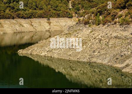 Susqueda Reservoir, in the Guilleries region, during the summer drought of 2022 (La Selva, Girona, Catalonia, Spain)  ESP: Embalse de Susqueda Stock Photo