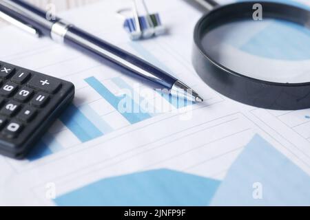 financial graph, calculator and notepad on table  Stock Photo