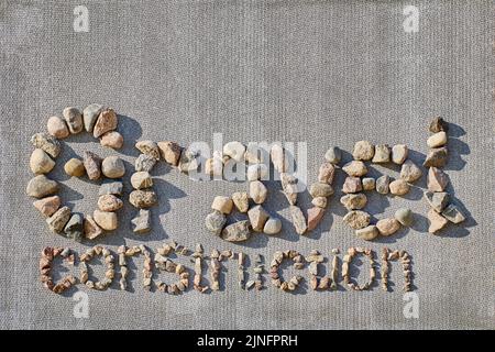 Text of inscription construction gravel is lined with rubble on slate slab. Stock Photo