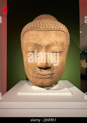 Head of a Buddha; Thailand, circa 14th century; Sandstone with traces of laquer; Brooklyn Museum, NYC. The head stood atop a massive standing or seated figure of the Buddha Shakyamuni. Stock Photo