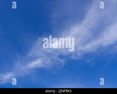Fluffy clouds floating scattered across the sky Stock Photo