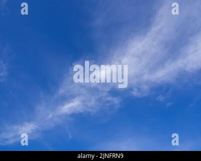 Fluffy clouds floating scattered across the sky Stock Photo