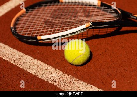 Broken tennis racket on clay tennis court Stock Photo