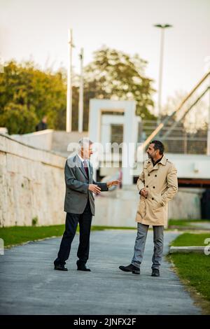 Two amazinf senior businessmen are standing and talking Stock Photo