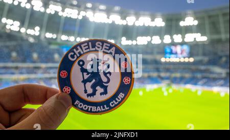 September 12, 2021, London, United Kingdom. The emblem of the Chelsea F.C. football club on the background of a modern stadium. Stock Photo