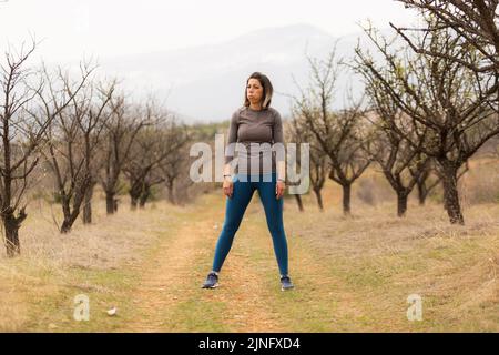 Middle aged woman is taking a breath from working out Stock Photo