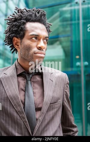 Man in blue pinstripe suit in tailors boutique stock photo