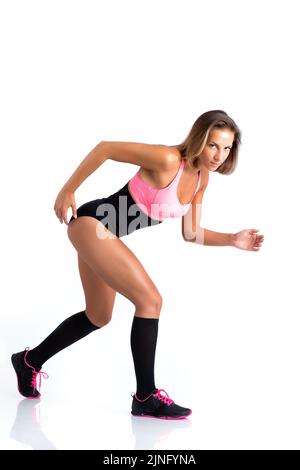 An athletic female doing exercises on white background Stock Photo