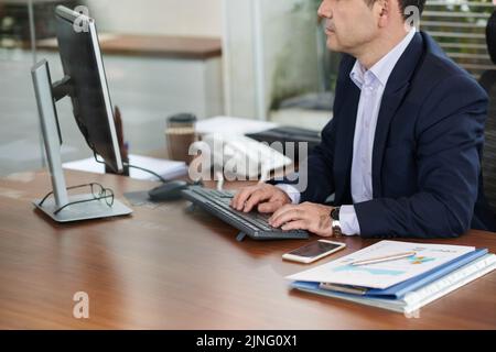 Cropped image of businessman working on computer Stock Photo