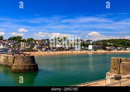 The historic harbour at Saundersfoot is filled with both pleasure craft and fishing boats with the town beyond, Pembrokeshire, Wales, UK Stock Photo