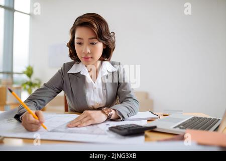 Portrait of young Asian architect working on project Stock Photo