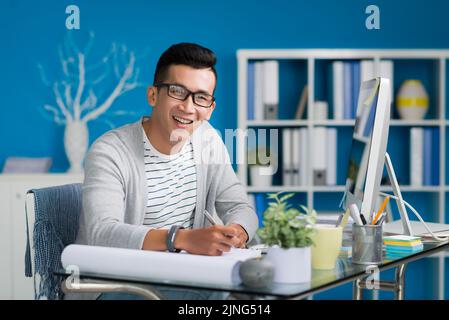 Happy young business man enjoying work on construction project Stock Photo
