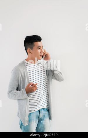 Portrait of young smiling man calling on the phone Stock Photo