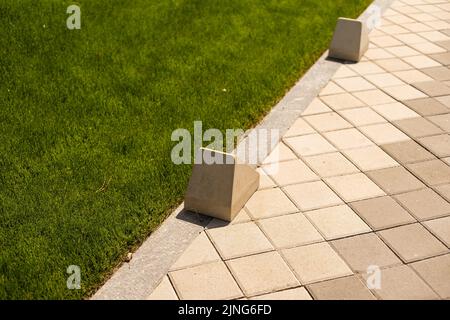 Pavement repair and laying of paving slabs on the walkway, stacked tile cubes on the background. Laying paving slabs in the pedestrian zone of the Stock Photo