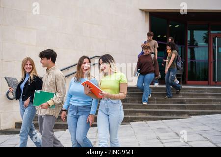 Group of students leaving the university library Stock Photo