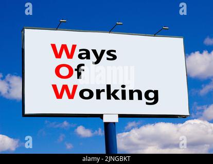 WOW ways of working symbol. Concept words WOW ways of working on white billboard against blue sky and clouds. Beautiful background. Business and WOW w Stock Photo