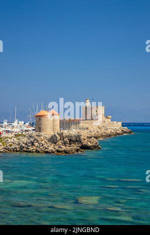 Windmills of Mandraki harbour and Saint Nicholas Fortress in Rhodes town, Greece, Europe. Stock Photo