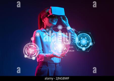 Happy young business lady using virtual reality interface Stock Photo