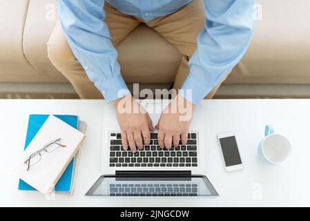 Senior man working on laptop, view from the top Stock Photo