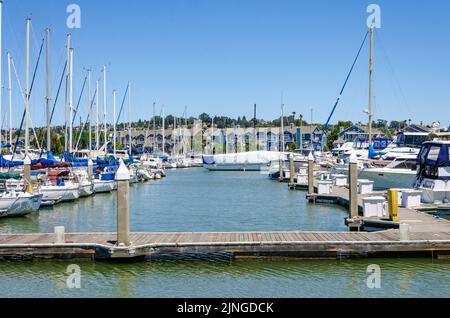 Pleasure boats moored against a pontoon in Benicia Marina in California ...