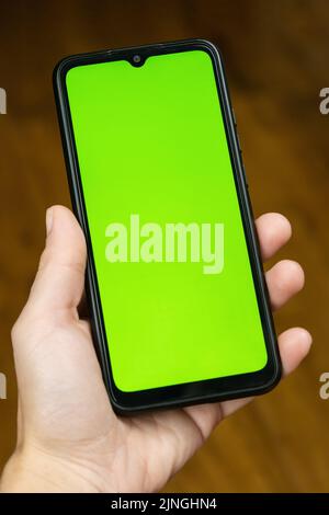 green chroma key hand with phone mockup pattern. Stock Photo