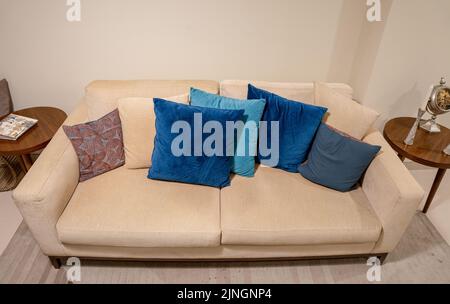 A closeup of a beige sofa with beautiful pillows in a living room Stock Photo