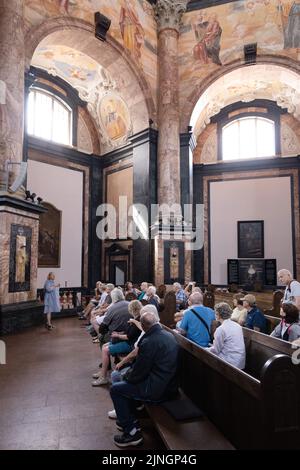 Tour guide giving a guided tour to tourists, the interior, Pazaislis Monastery and church, Kaunas, Lithuania Europe Stock Photo