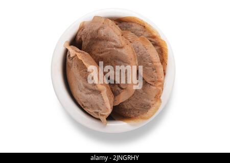 Used teabags in white bowl shot from above isolated on white background Stock Photo