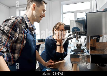 Kiev Ukraine - april 29 2018: Young family makes coffee in a cafe. Family business concept Stock Photo