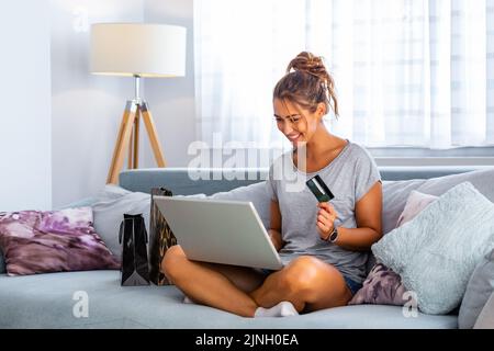 Picture showing pretty woman shopping online with credit card. woman holding credit card and using laptop. Online shopping concept Stock Photo