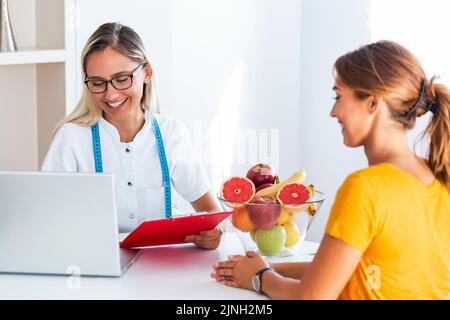 Doctor nutritionist, dietician and female patient on consultation in the office. Stock Photo
