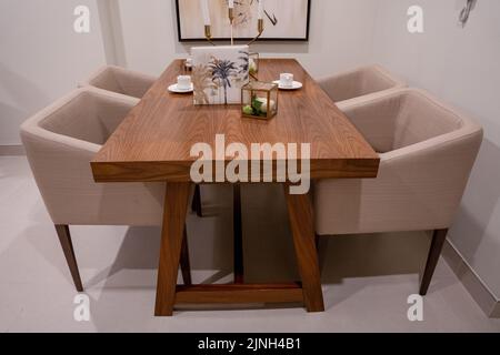 A modern dining table in a bright spacious studio apartment in Scandinavian style Stock Photo
