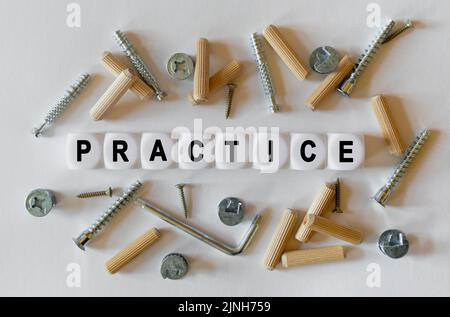 Construction business concept. On a white background, building fittings and white cubes with the inscription - practice Stock Photo