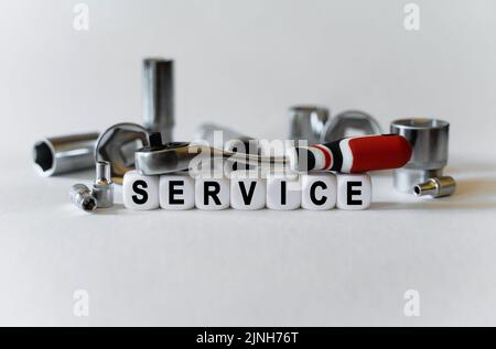 Business concept. On a white background, a set with tools and white cubes with the inscription - service Stock Photo