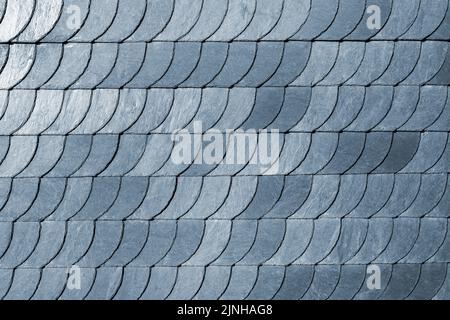 Detail close-up of natural grey stone shingle slate tiles texture roof abstract surface background. Natural mineral material dark rock plate building Stock Photo