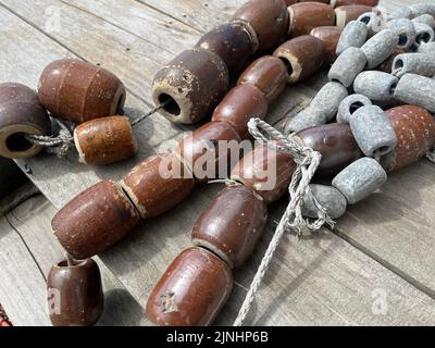 Strings of ceramic and lead fishing weights Stock Photo