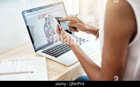 Communication is a key ingredient to success. High angle shot of an unrecognizable young businesswoman reading a text message while working in her Stock Photo