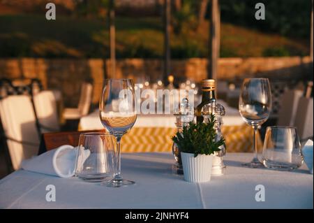 Table setting for dinner in open space during sunset Stock Photo