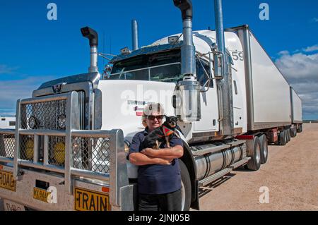 Woman truck driver, Faye Francis-Lewis, with her B Double truck in which she hauls 75 tonnes of tomatoes twice a week between Perth and Adelaide, covering a distance in excess of 10,000 km. Stock Photo